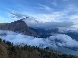 a mountain obscured by clouds in a valley at Oke rinjani in Bayan