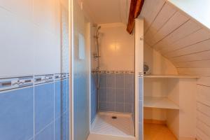 a bathroom with a walk in shower next to a closet at Gite La Bergerie près de Lourdes in Adé