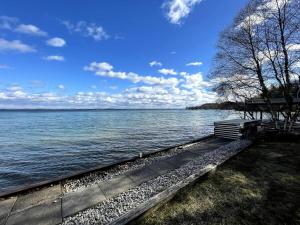 a bench sitting next to a body of water at Lakefront Bliss on Old Mission Peninsula in Traverse City