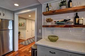 a kitchen with a counter top and a refrigerator at Lakefront Bliss on Old Mission Peninsula in Traverse City +18 photos