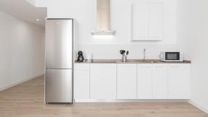Η κουζίνα ή μικρή κουζίνα στο GM Toledo Apartamentos by Toledo AP
