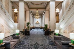 a lobby with couches and a chandelier at Kimpton Hotel Monaco Baltimore Inner Harbor by IHG in Baltimore