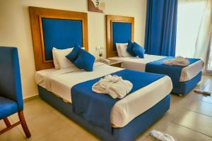 Cama ou camas em um quarto em Tropitel Dahab Oasis