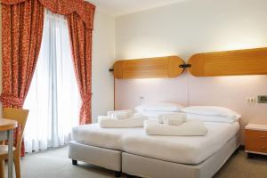 Łóżko lub łóżka w pokoju w obiekcie Club Hotel e Residence La Vela