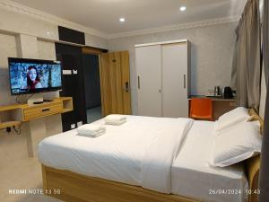 Letto o letti in una camera di Arasan Residency