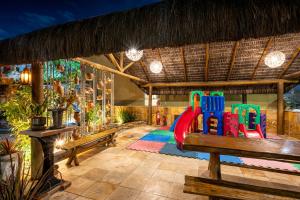 a play room with a playground with a slide at Natal Dunnas Hotel in Natal