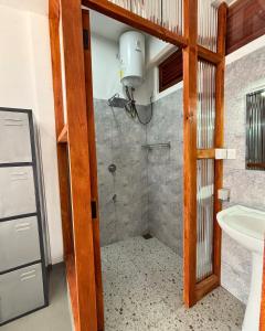 a bathroom with a shower and a sink at Surfing Tusker - Thalpe in Talpe +31 photos