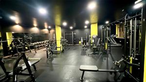 a gym with rows of machines and weights at Best Western Hotel Blumarea in Castelsardo
