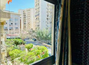 a window with a view of a city at BlueHostel in Cairo