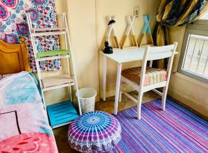 a room with a desk and a chair and a rug at BlueHostel in Cairo