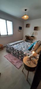 a bedroom with a bed and a table at Chez bigoudy in Penta-di-Casinca +44 photos