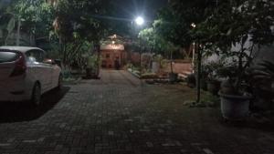 a car parked on a brick road at night at Ndalem Katresnan Kalongan "Homestay" in Prambanan