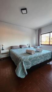 a bedroom with a bed with two pillows on it at Departamento Pedernera in Godoy Cruz