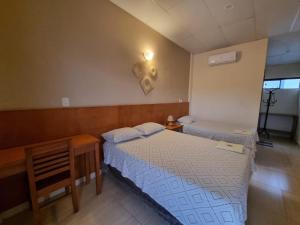 Postel nebo postele na pokoji v ubytování Hotel Karanda´y