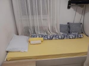 a bed in a small room with a window at Djordje in Belgrade
