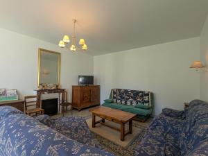 a living room with a couch and a table at Moulin paisible en Berry avec étang privé, proche du Château de Valençay et Zoo de Beauval - FR-1-591-18 in Chabris