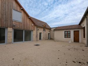 an empty parking lot in front of two buildings at Maison de plain-pied en Brenne avec cour close, Wifi et proche de Châteauroux et étang de pêche - FR-1-591-104 in Neuillay-les-Bois