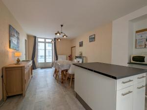 a kitchen with a counter and a dining room at Maison de plain-pied en Brenne avec cour close, Wifi et proche de Châteauroux et étang de pêche - FR-1-591-104 in Neuillay-les-Bois