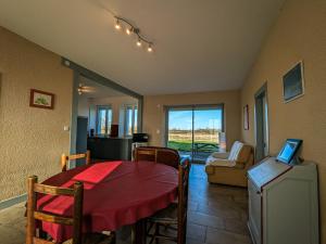 a living room with a table and a couch at Gîte en Brenne avec Terrasse et Garage Privé - FR-1-591-316 in Migné