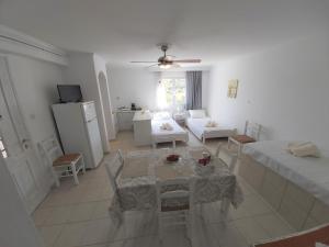a living room with a table and a couch at Dandelion Paros Apartments I-II in Kóstos