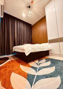 a bedroom with a bed and a large rug at The Shore Cozy Homestay, Heart of KK City Centre in Kota Kinabalu