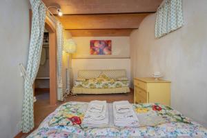a bedroom with a bed and a dresser in it at San Giovanni Residence in Peccioli