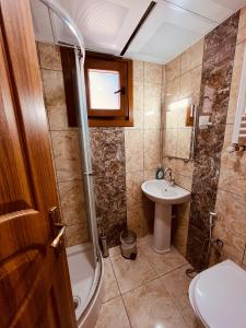 a bathroom with a sink and a shower and a toilet at Desera Pansiyon in Uzungöl +52 photos