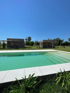 an empty swimming pool in front of a house at La Tranquila Suites de Campo in Victoria
