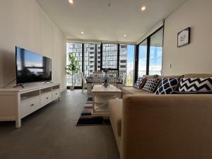 悉尼Stadium View Oasis 2BR with Free Parking的配有沙发和平板电视的客厅