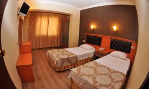 Postel nebo postele na pokoji v ubytování Epic Hotel