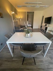a white table and chairs in a living room at Hexe III in Altenau