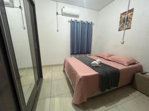 a bedroom with a bed with a stuffed animal on it at Rosy Flat 1 Andar in Petrolina