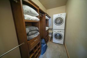 a laundry room with a washer and a washing machine at Frey Gulch 46 by SummitCove Lodging in Keystone