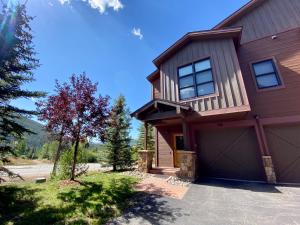 a brown house with a garage at Frey Gulch 46 by SummitCove Lodging in Keystone
