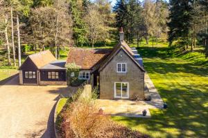 an aerial view of a house in a field at Marvellous secluded forest lodge - Stone Hall in Eyke