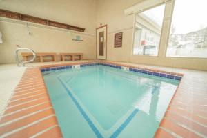 a large swimming pool with blue water in a building at Flying Dutchman 1192 by SummitCove Lodging in Keystone +43 photos