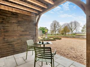 a patio with two chairs and a table at Owl's Perch - Otium Wine Estate in Alton +8 photos