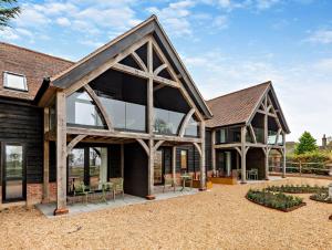 an exterior view of a house with large windows at Owl's Perch - Otium Wine Estate in Alton