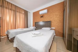 a hotel room with two beds with towels on them at Marina Apart Hotel in Marmaris +23 photos