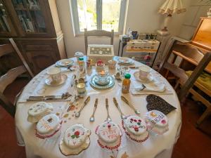 a table with cakes and spoons on top of it at Maison d'hôtes de charme du XIXe, proche Château de Valençay et Zoo de Beauval - FR-1-591-392 in Valençay +22 photos