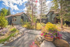 a house with flowers on the side of a road at Soda Spring 1910 by SummitCove Lodging in Keystone