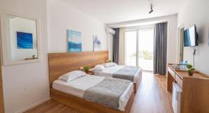 Postel nebo postele na pokoji v ubytování Hotel Besani