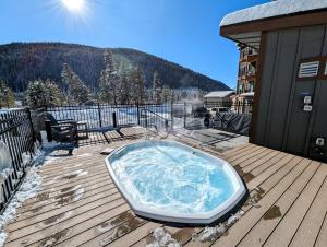 a hot tub sitting on top of a deck at Clearwater Lofts Bldg 3 103 by SummitCove Lodging in Keystone