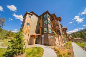an exterior view of a house with mountains in the background at Clearwater Lofts Bldg 3 103 by SummitCove Lodging in Keystone