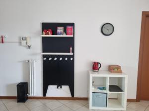 a room with a black cabinet and a white shelf at Studio with terrace in Busto Arsizio