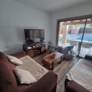 a living room with a couch and a tv and a table at Utopia in Puigventos