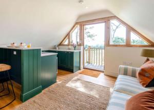 a living room with green cabinets and a couch at Vineyard View - Otium Wine Estate in West Worldham +10 photos