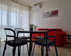 a table and chairs in a living room with a couch at Studio with terrace in Busto Arsizio +6 photos