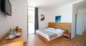 Postel nebo postele na pokoji v ubytování Hotel Besani