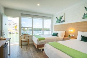 a hotel room with two beds and a large window at Gilbert's Resort & Marina in Jewfish +172 photos